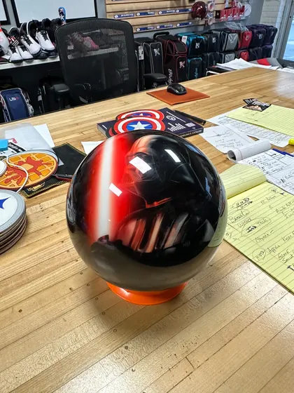Phone photo of the same ball on the counter, seen from the back