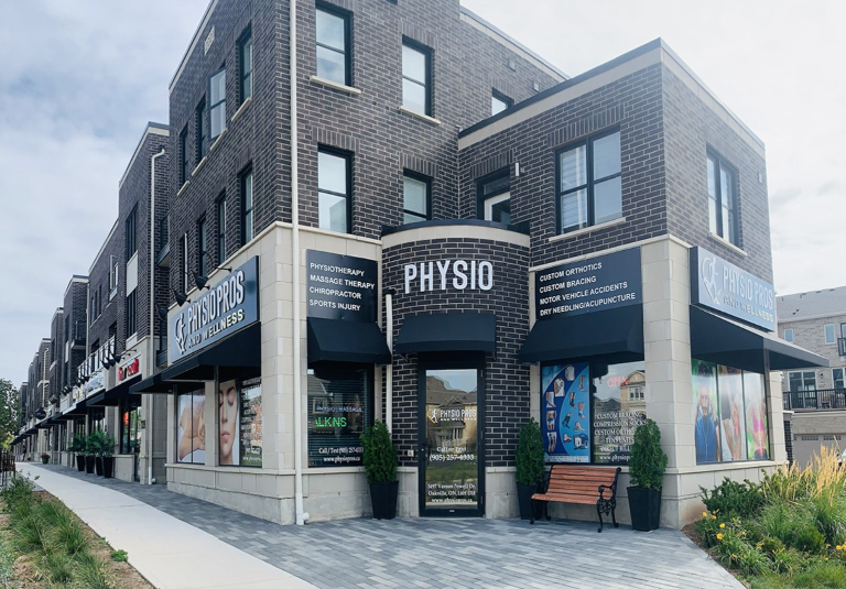 A building with an entrance under a PHYSIO white sign
